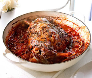 Herby baked lamb in tomato sauce: Easter recipe for a shoulder of lamb roasted in a herbed tomato sauce base until very tender.