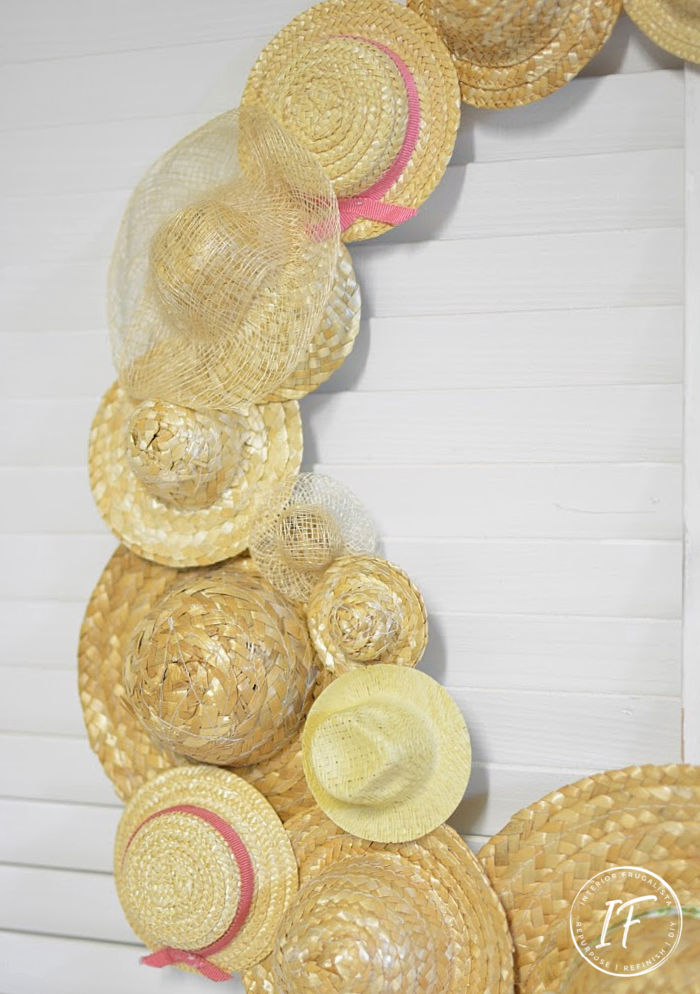 An easy DIY Summer Hat Wreath idea with recycled miniature straw hats. A budget-friendly summer craft idea with thrift store and dollar store finds.