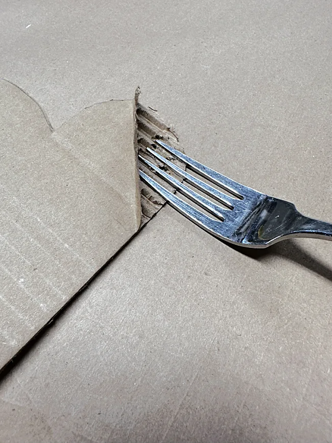 fork peeling cardboard