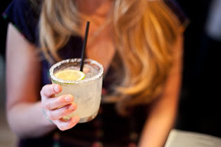 a woman celebrates her birthday with a margarita