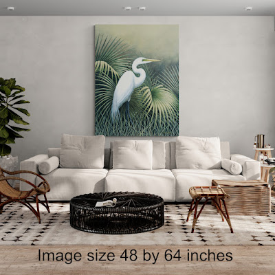 white egret standing among palm leaves