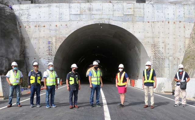 Public Works Sec. Mark Villar, flanked by SBMA Chairman and Administrator Wilma T. Eisma and NLEX Corp. president and general manager J. Luigi Bautista, walks along the new lanes of the Subic Freeport Expressway past the new tunnel during the soft opening of the expanded expressway on Monday.