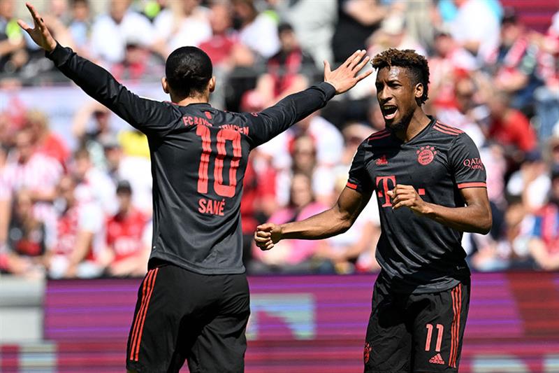 Bayern Munich s French forward Kingsley Coman (R) celebrates scoring the opening goal with Bayern Munich s German midfielder Leroy Sane during the German first division Bundesliga football match between FC Cologne and FC Bayern Munich in Cologne, western Germany on May 27, 2023. AFP