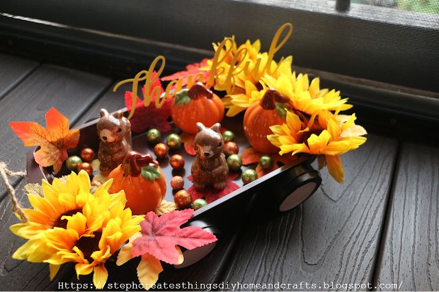 Completed fall wagon with squirrel and pumpkin figurines along with faux fall foliage and floral