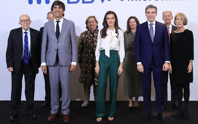 Queen Letizia wore Teleah green trousers by Hugo Boss, and white bow silk blouse by Carolina Herrera