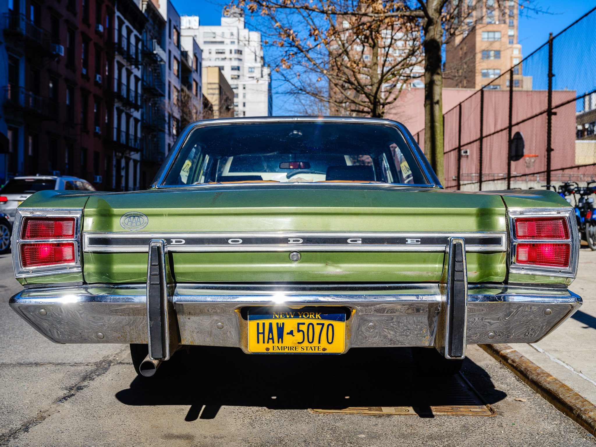 a photo of a classic green dodge dart in new york city