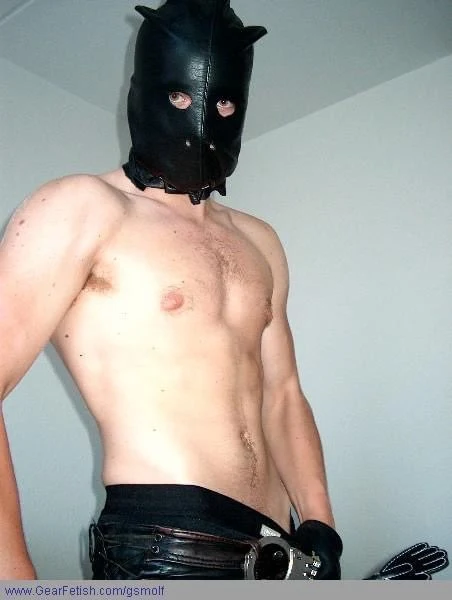 From waist up wearing black leather pants, hood and gloves muscular man