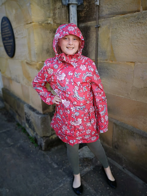 child modelling joules raincoat