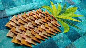 Pineapple Twist quilt pattern using prairie points to create texture