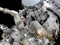 Russian cosmonauts relocate airlock on International Space Station spacewalk.