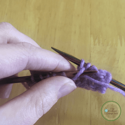 Picture of sliding a purl stitch off the knitting needle