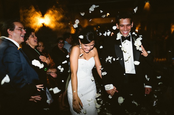 Guests threw white rose petals as the couple departed for their honeymoon