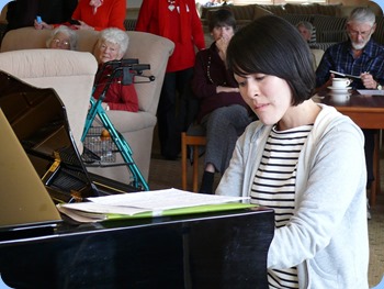 Kuniko Nakatani playing the Kohler and Campbell grand piano with great sensitivity of touch. Photo courtesy of Dennis Lyons.