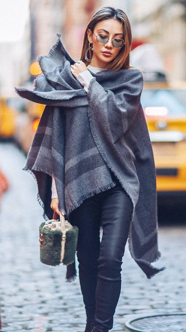 what to wear with a poncho : leather pants + fur bag + sweater 