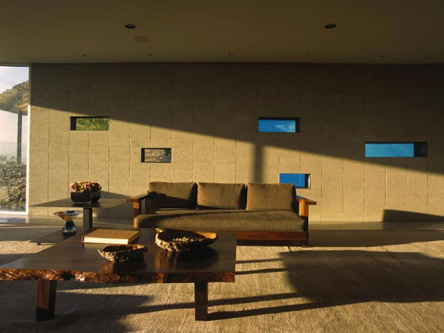 Photo of wooden furniture by the wall with pool windows