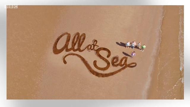 Title card from the CBBC show All at Sea. Show title written in sand with family looking up.