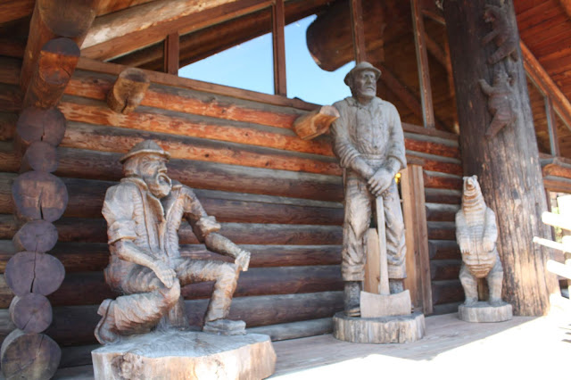 Logger and bear woodcarvings greet guests at Camp 18 in Elsie, Oregon