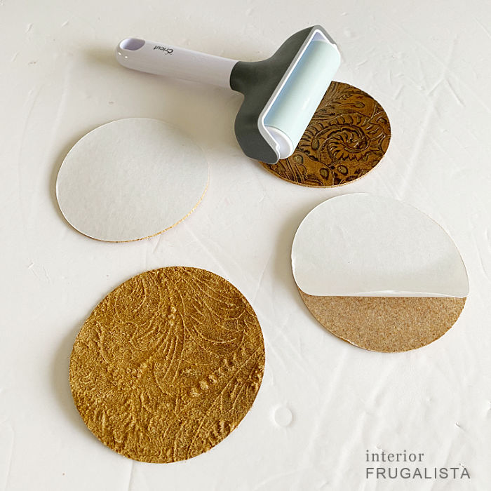 Make easy DIY leather coasters with cork and leather circle cut outs.