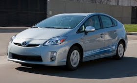 Front 3/4 view of blue 2012 Toyota Prius Plug-In Hybrid driving
