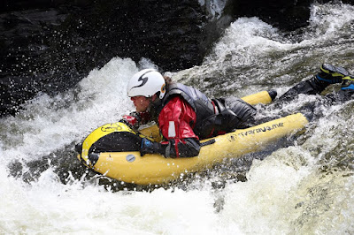 A White water bug with man racing down river