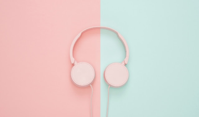 Pink headphones on pink and blue background
