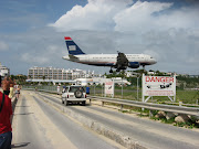 US Airways A319. A tad low but OK. Note the sign warning of the jet blast (us air sxm)