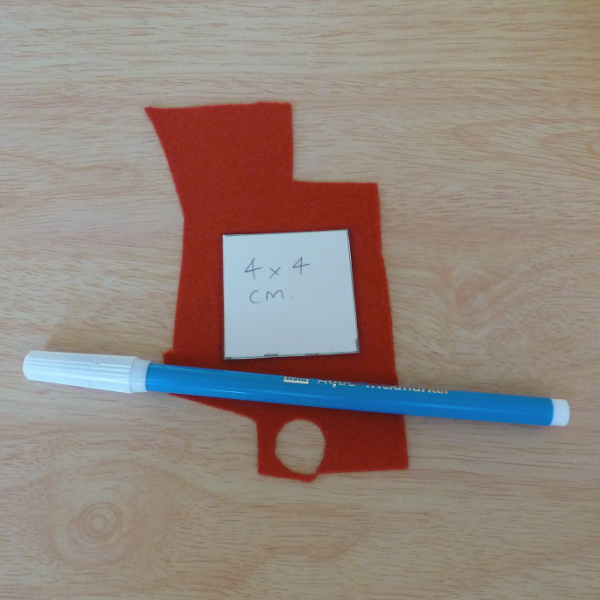 Square cardboard template with red craft felt and a water soluble fabric marker