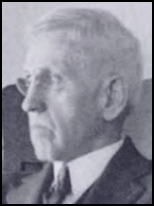 Profile shot of a scowling elderly white man with glasses and thick, white hair cut short
