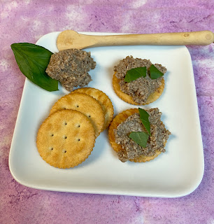 vegan pate on a square plate with crackers