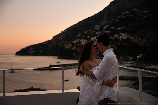 Bride and groom kiss at sunset