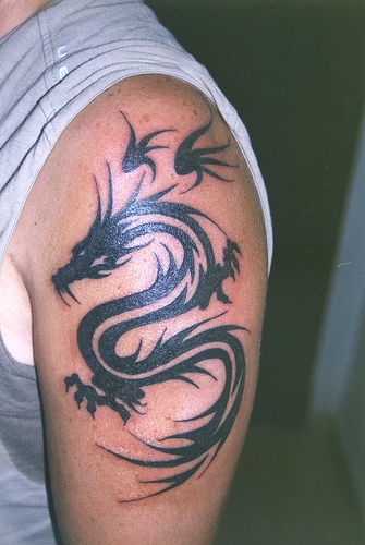 Tribal Tattoo In Arm. Tribal Dragon Tattoos