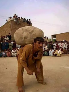 MAN-LIFTING-STONE-WITH-HIS-BACK