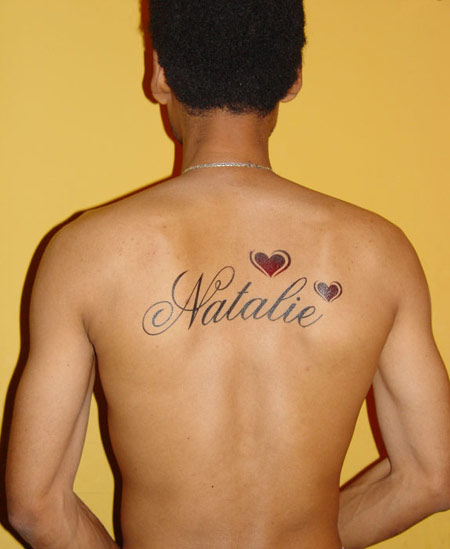 tattoos names on back. Saw a girl this morning on the way home from Work with some guy's name on 