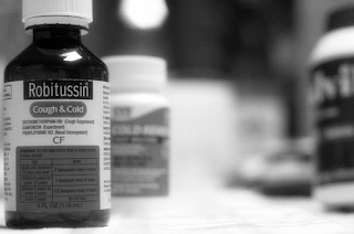 cough syrup, robitussin, black and white, bottles