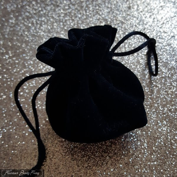 small black velvet pouch for Lancome limited edition palette on glitter background