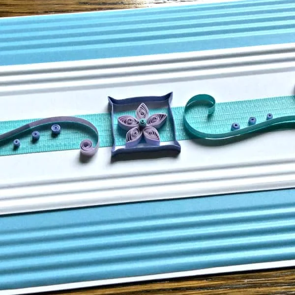 handmade pastel rectangular quilled card with scrollwork and flower