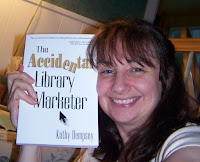 author Kathy Dempsey holding her book, The Accidental Library Marketer 