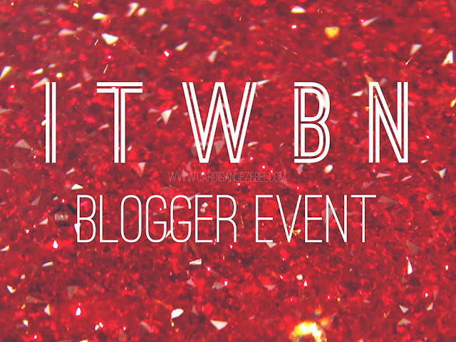 White geometric text reading "ITWBN Blogger event" Over a red glitter/crystal background