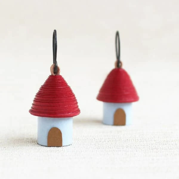 pair of tiny rolled paper bead earrings that resemble cottages