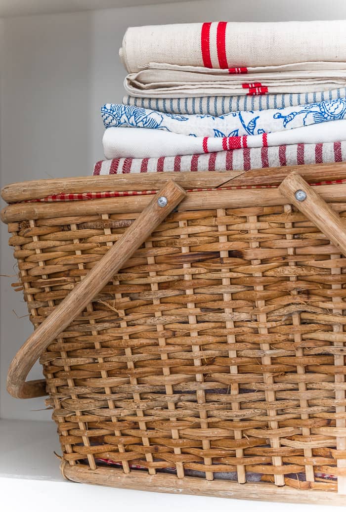 vintage picnic basket, stacks of red, white and blue fabrics