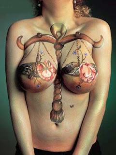 Sexy woman with a Libra zodiac tattoo on breast