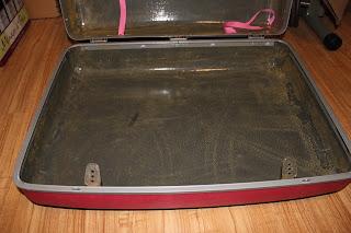 Recycled crafts:  cleaning the repurposed suitcase