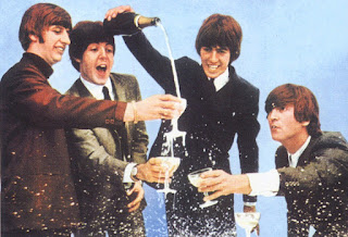 Picture of the band The Beatles celebrating with champagne