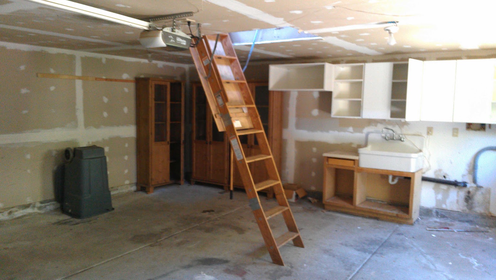 Garage With Ladder To Storage Loft