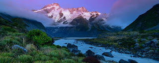 A sea inlet with mountains rising up around it.