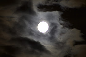 super moon through clouds