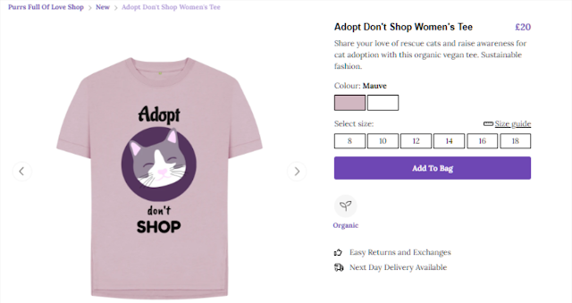 T-shirt with drawing of a cat face with the words Adopt Don't Shop