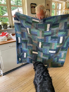 Bill holding the quilt Carol made for him