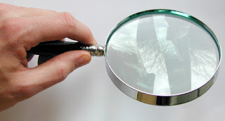 Man holding a round magnifying glass