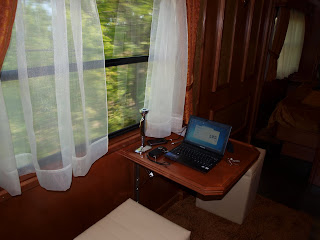 Netbook on table by railway carriage window